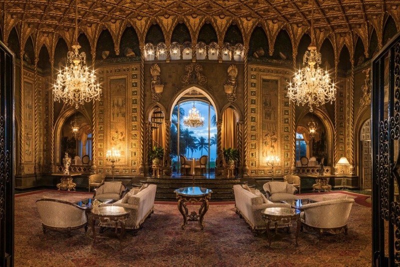 Living room inside Mar-a-Lago with a gold-leaf ceiling inspired by the Academia’s “Thousand Wing Ceiling” in Venice. Photo from the Mar-a-Lago website.