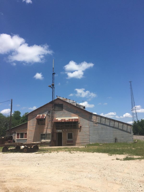 Pictured here is the original peanut dryer built in the early 1930s. This building still stands today with its original signs.