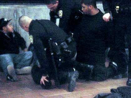 New Years Day 2009, Oscar Grant being aggressively pinned down by BART police officers, moments before he was fatally shot in the back.