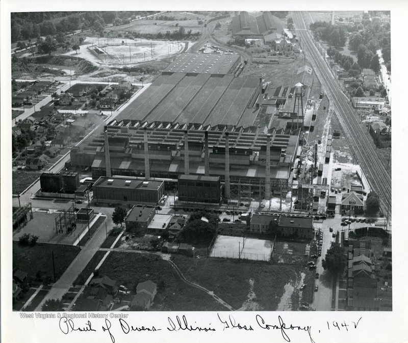 The bumper plant is visible in the background of this photo of the nearby Owens-Illinois factory