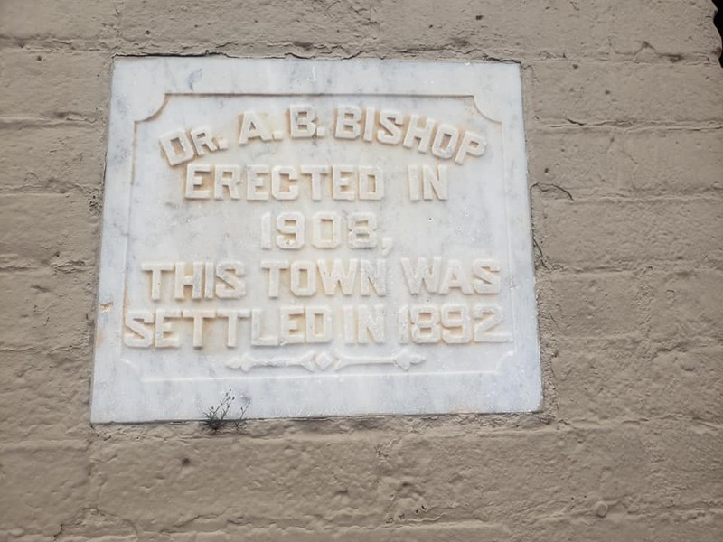 This plaque is located on the west corner of the building.