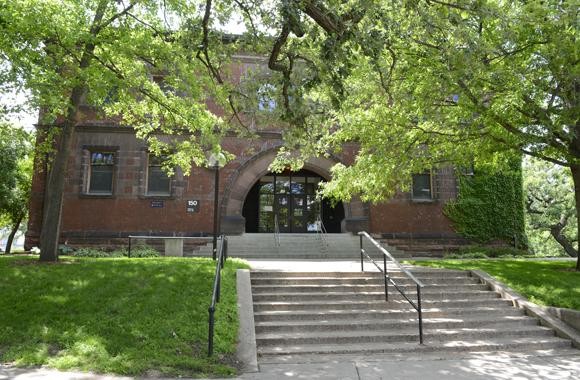 The building is surrounded by trees, as part of the University's park-like landscaping plan