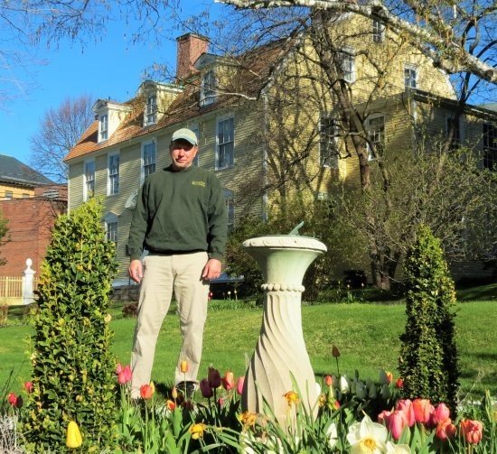 A volunteer with the Portsmouth Historical Society works on the house's garden.