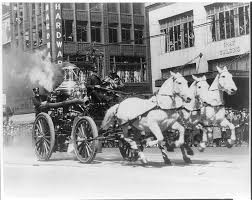 Early photo (c. 1900-1920) showing an example of a horse-drawn fire wagon pulling a steam engine used to pump water