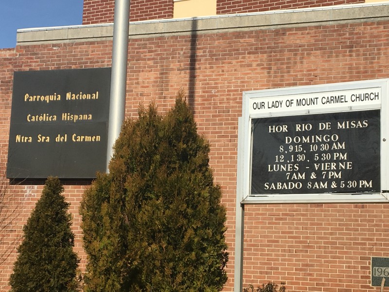 Picture of plaque on church facade sign post outside front of the church