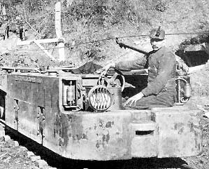 Miner on shuttle car, early 1900s.