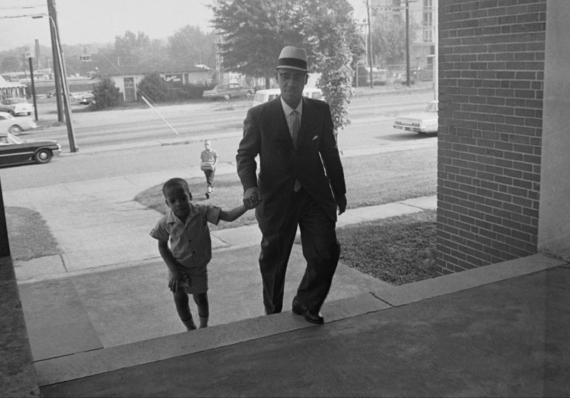 Dr. Sonnie W. Hereford III escorts his son Sonnie Hereford IV into Fifth Avenue School