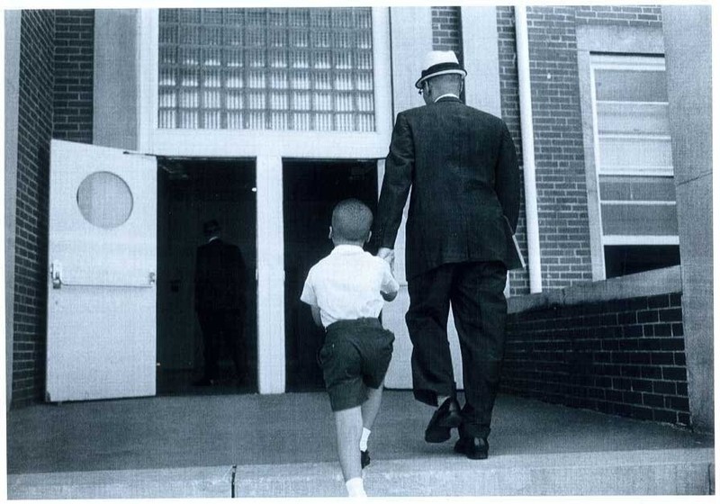 Dr. Sonnie W. Hereford III escorts his son Sonnie Hereford IV into Fifth Avenue School