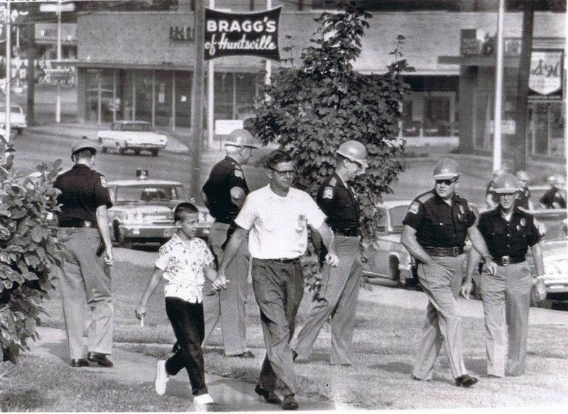 Alabama State Troopers fill the campus of Fifth Avenue School to prevent integration of the school. Note the Bragg's Furniture sign in the background, which still stands today on the north side of Governor's Drive. 