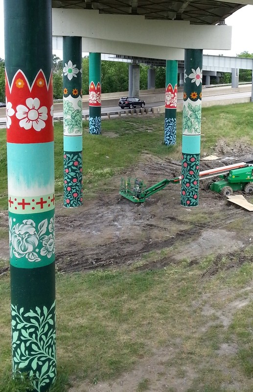 The mural located on the pillars of a highway overpass.
