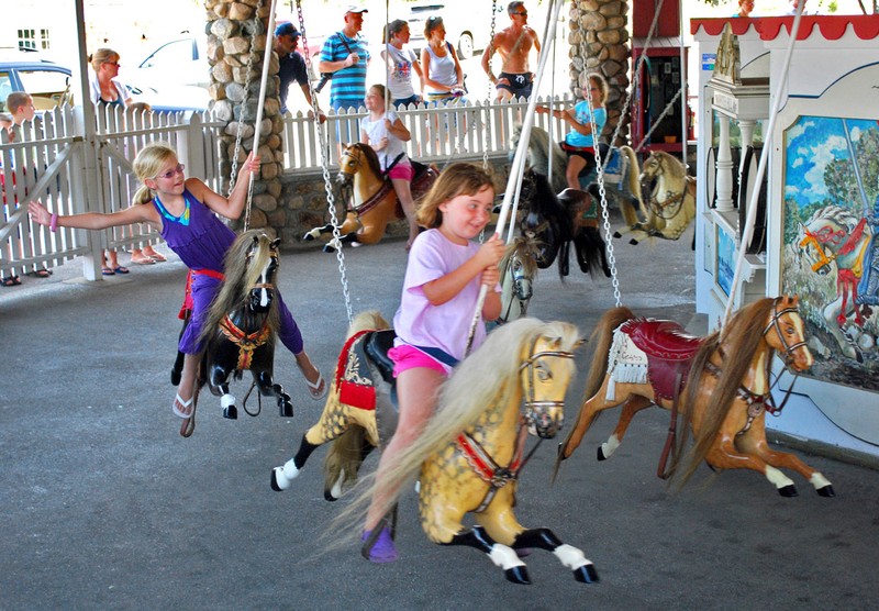 Children riding modern version of Flying Horse Carousel