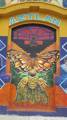 The old doorway that once led visitors inside Casa Aztlan is repainted with symbols from the original mural, including the Black Aztec eagle (Credits: Elena Andrews, 2019)