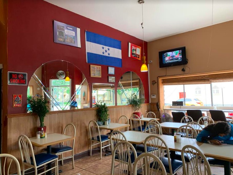 The inside of the restaurant has a quaint feel and is decorated with Honduran souvenirs and flags.