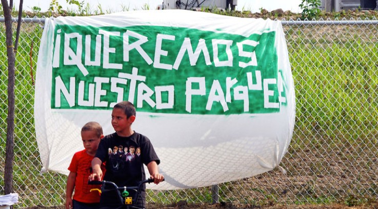 While the white sheet could have been a flag of surrender, it was marred with green paint, the color of hope. Activists hung this sign as a part of the fight for the realization of this hope: that there would be a park to call "ours."