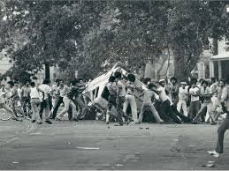 https://chicagoganghistory.com/division-street-riots/
This picture is from the 1966 Division Street Riot. The image shows rioters flipping a car over. Over the course of the three day riot many cars were flipped and many buildings were destroyed. Es