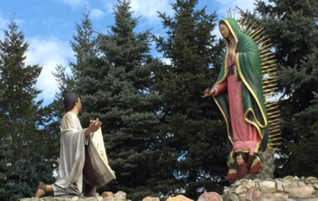 This sculpture is known as "The Offering." It depicts the scene in which Our Lady of Guadalupe appears to Saint Juan Diego. It shows her leaving her image on his cloak as the final indication that her presence is in fact real. 