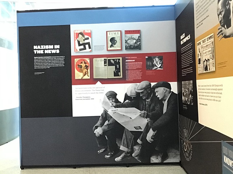 Magazine covers and newspaper articles display symbols and stories of Nazism in the news