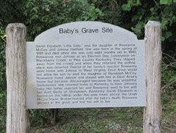 A sign shares the story of Sally McCoy who is buried close to the official McCoy Cemetery