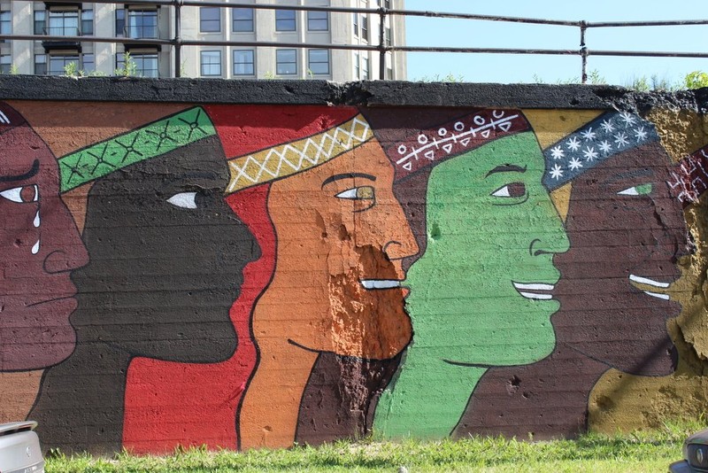 The faces then become happier and continue to change colors while retaining the same features; this could symbolize how much one Latino endures and changes in his life.