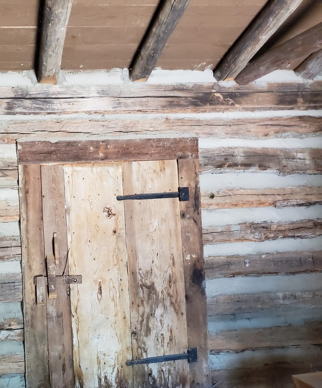 This is a view of the schoolhouse door from the inside. Windows were open holes cut into the logs to provide light and ventilation during warm weather but there was no glass or closures to keep the outside elements out.