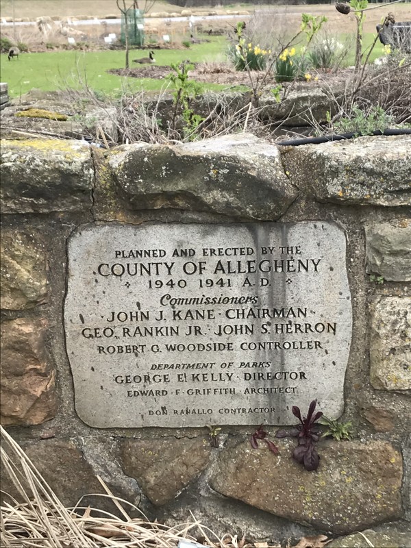A small stone plaque near the cannon, which is titled "Planned and Erected by the County of Allegheny 1940 1941 A.D."