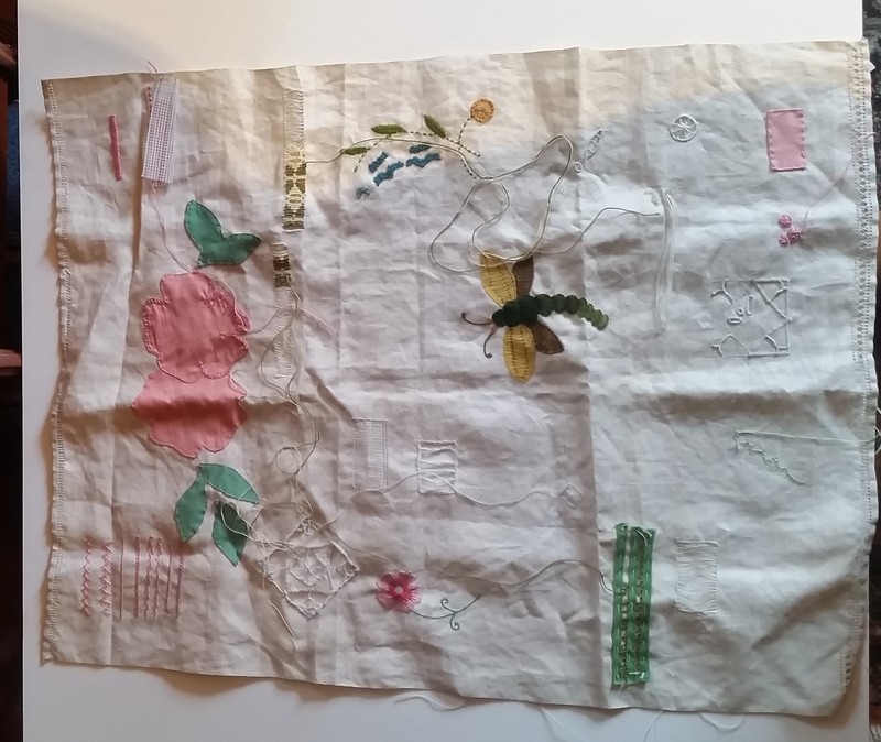 This sampler was found in a sewing basket belonging to Esther Sybilla Hefty, 1883-1963. A sampler was used by young girls or women to practice stitching techniques. Patterns were stenciled onto the fabric as a guide.