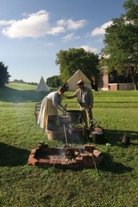 Civil War reenactors prepare for a meal on Governors Island. 