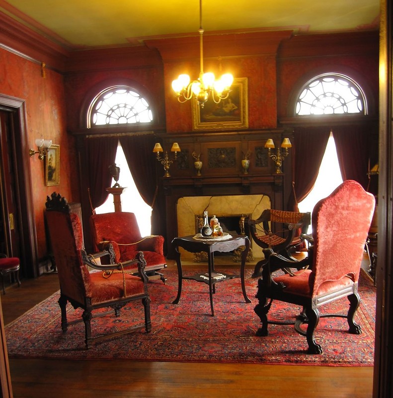 The mansion features many large rooms and antique furnishings.