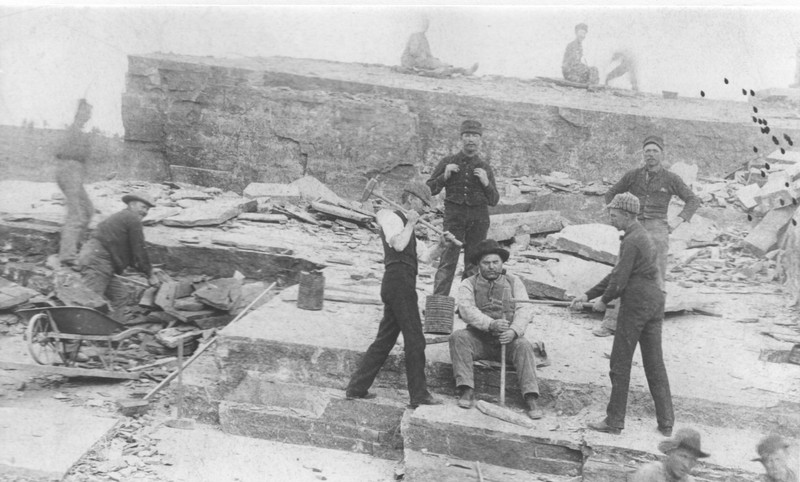 Historic photo of quarry workers using a drill to break apart sandstone. Photo courtesy of the Lyons Redstone Museum. 