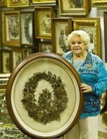 A photo of Leila with one of the hair wreath's in her museum's collection from the museum facebook page.