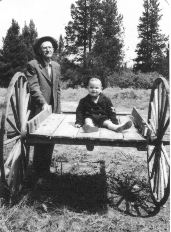 Louis Wildhack and his grandson, sitting on the wagon used to carry mail from the post office to the train depot. Circa 1920