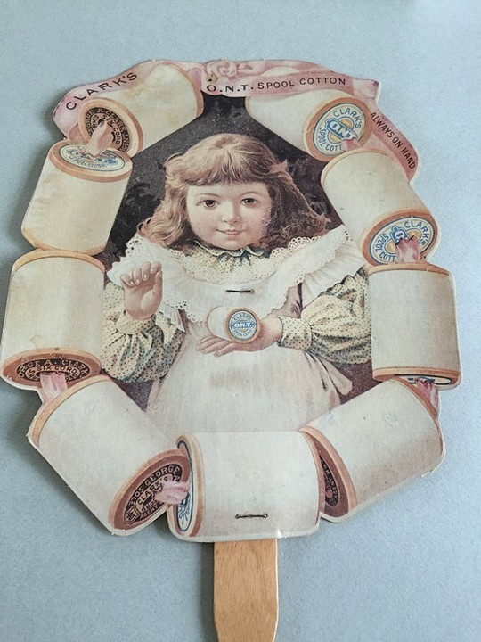 A fan in the Hand Fan Museum's collection from the early 20th century featuring an advertisement for spools of cotton thread.