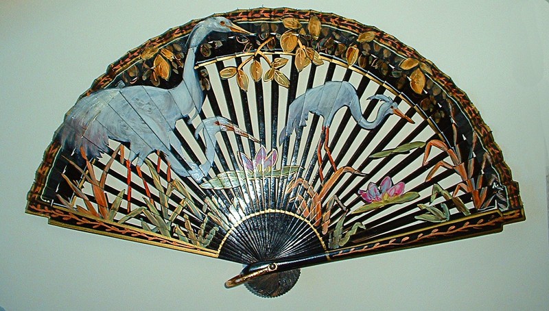 Hand painted blue herons on a fan in the museum's collection.
