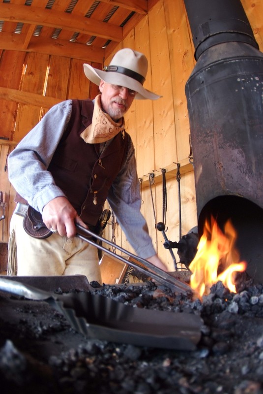 Another Four Mile docent and Blacksmith works the forge