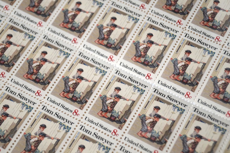 On October 13, 1972, the U.S. Postal Service released an 8-cent Tom Sawyer commemorative stamp to celebrate the popular novel written by Mark Twain. This sheet of stamps was signed in the top left corner by sitting president, Richard M. Nixon.