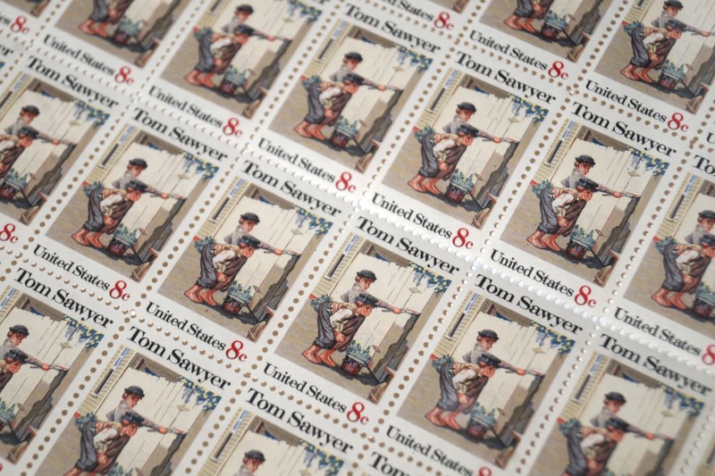 On October 13, 1972, the U.S. Postal Service released an 8-cent Tom Sawyer commemorative stamp to celebrate the popular novel written by Mark Twain.  This sheet of stamps was signed in the top left corner by sitting president, Richard M. Nixon. 