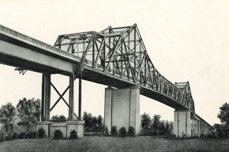 A black and white photo of an old bridge.