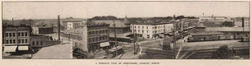 A panoramic view looking north from the railroad tracks into downtown Greensboro, showing in foreground the Cascade Saloon and Southern Railway station, among other buildings