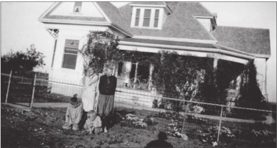 Gottlieb William Bohls' children (Leon, Fred, Lucile, and Alvin) standing in front of the historic Bohls House.