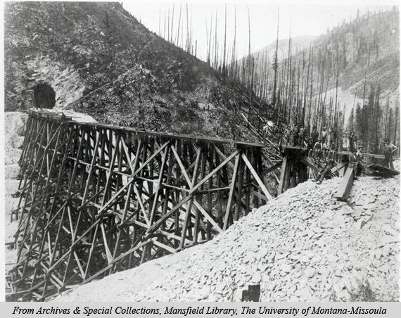 An image of a treeless and barren valley and tunnel and train tracks impacted by the 1910 fires.