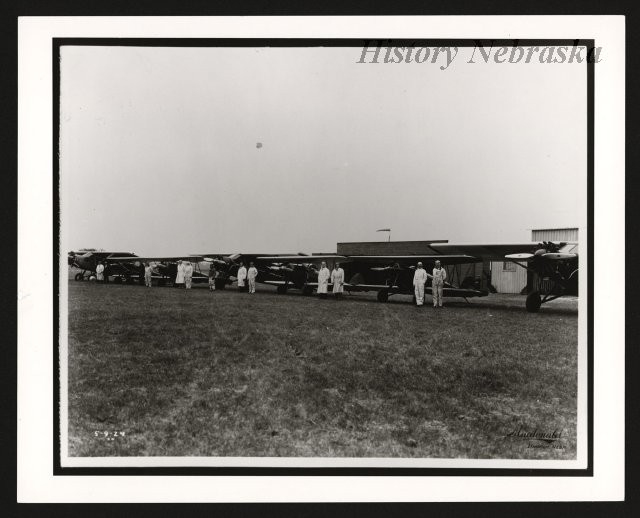 Various models of Arrow aircraft in front of hangars, c.1929