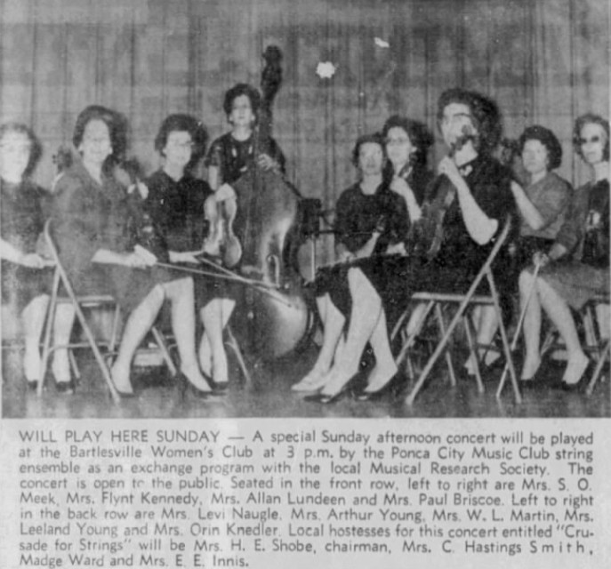 A photo from a newspaper showing women playing stringed instruments.