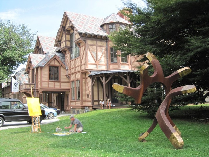 Outdoor art and an artist at work on the grounds of the Newport Art Museum.