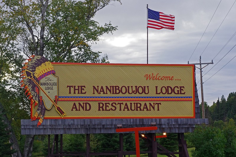 The lodge's welcome sign, featuring a Native American war bonnet incorporated into its logo.