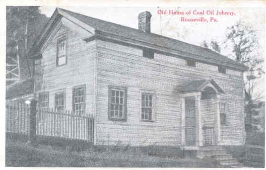 Black and white photo of a simple, rectangular home. 