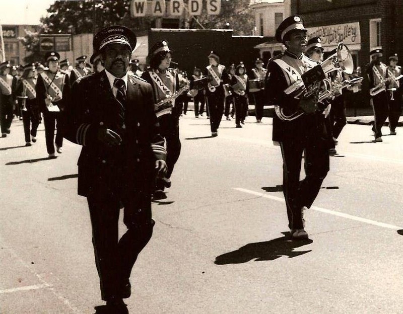 Band members march past Ward's during a parade