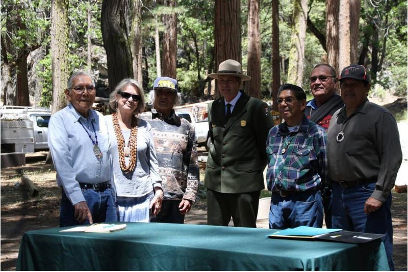 Superintendent Michael Douglas poses with members of the Mariposa Indian Council after returning possession of the Indian Village back to the council.