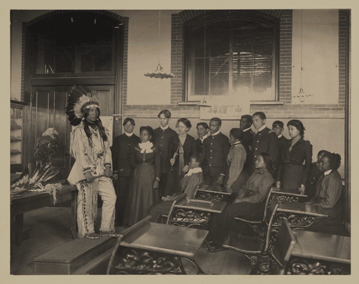 Native Americans in a class at Hampton University in the 1800s. This photo is courtesy of https://jubiloemancipationcentury.files.wordpress.com/2011/02/sioux-at-hampton-institute.png 