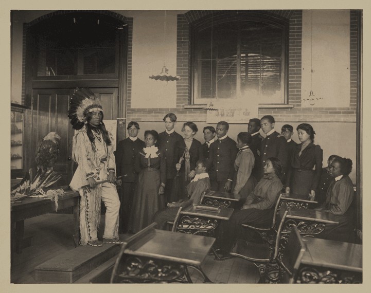 Native Americans in a class at Hampton University in the 1800s. This photo is courtesy of https://jubiloemancipationcentury.files.wordpress.com/2011/02/sioux-at-hampton-institute.png