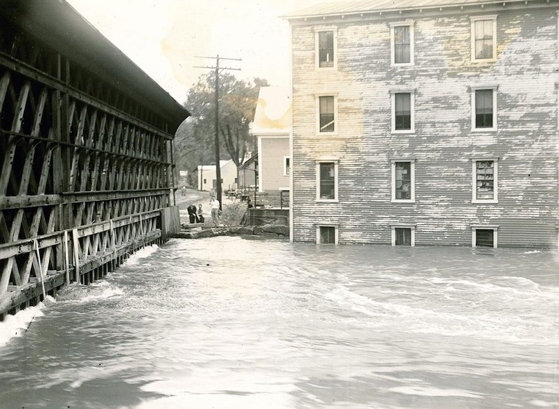 Image of the covered railroad bridge in Contoocook during high waters.